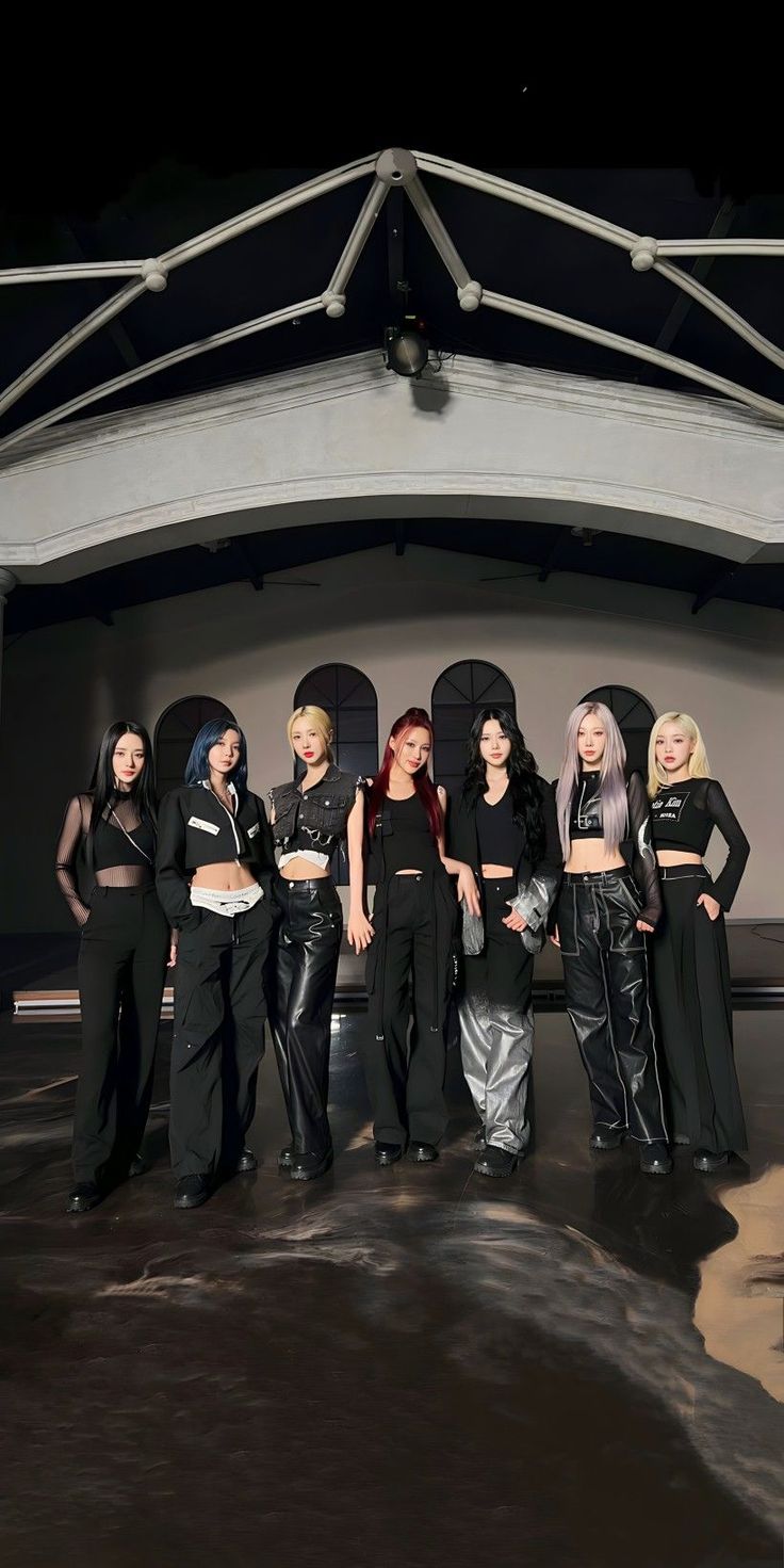 the group of women are posing together in black outfits