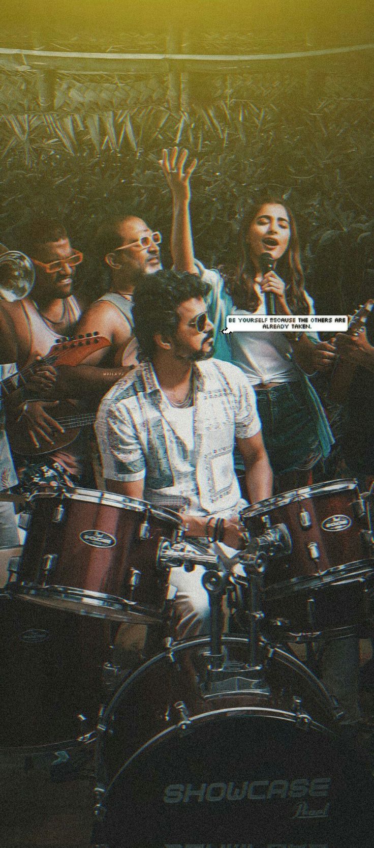 a group of people sitting in front of drums on top of a stage with their hands up