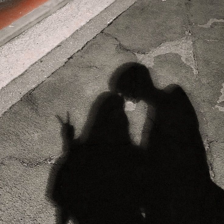 the shadow of a person holding a cell phone