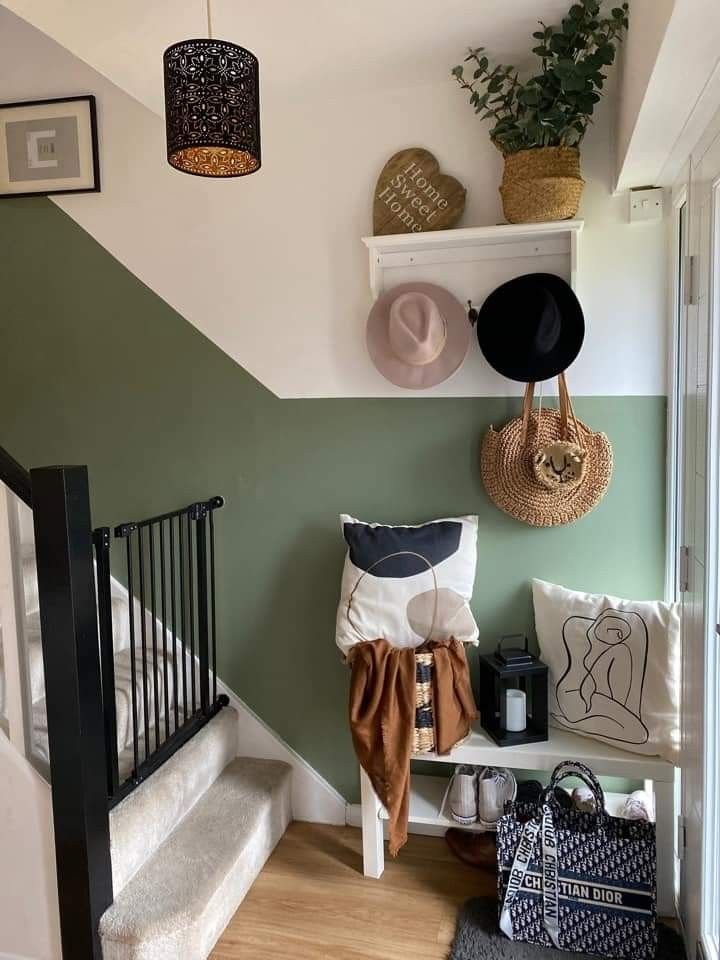 there are hats hanging on the wall next to some baskets and bags in this room