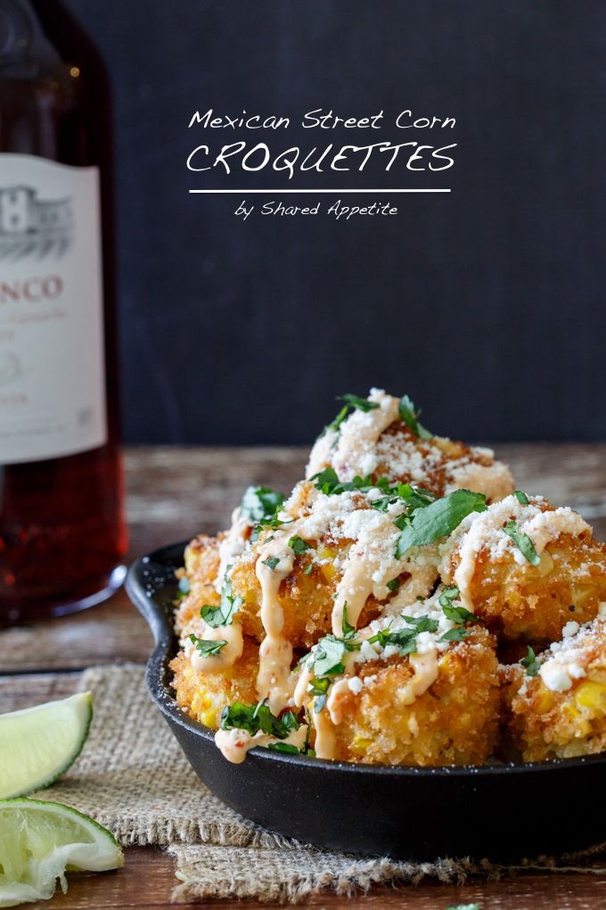 mexican street corn croquettes with shredded cheese and cilantro sauce in a cast iron skillet