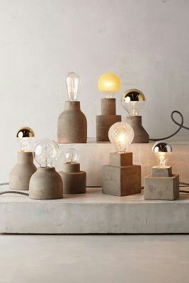 an assortment of light bulbs and lamps on a table