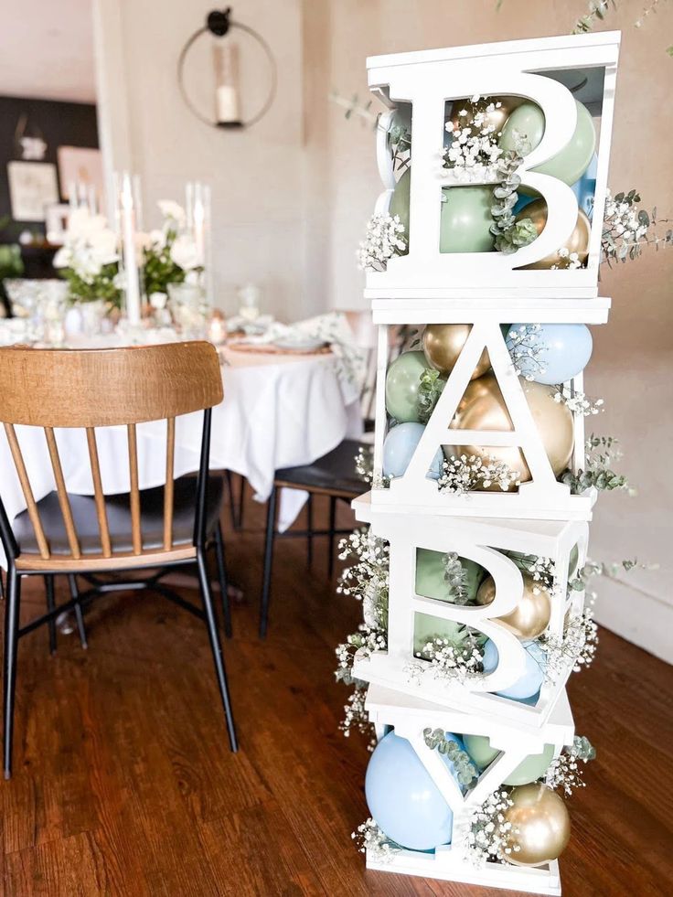 a wooden table topped with lots of white and blue decorations next to a dining room table