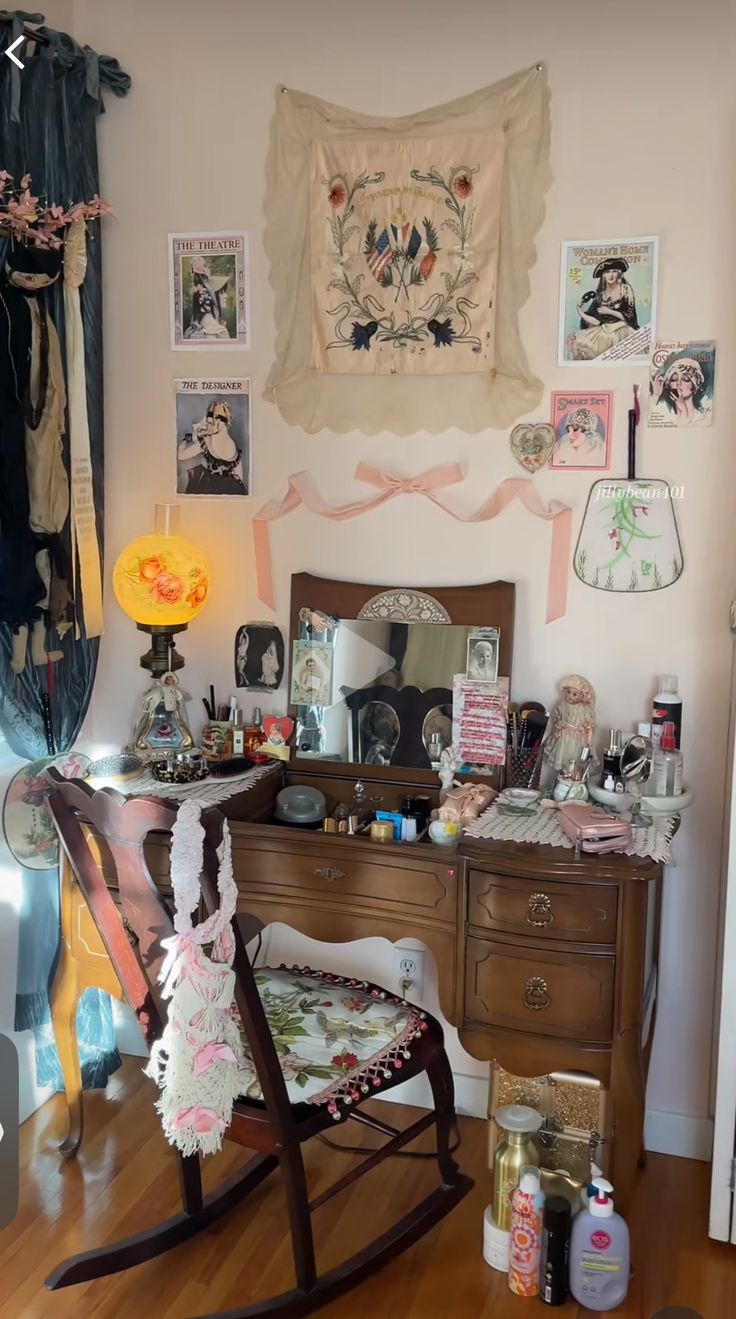 a room with a rocking chair, dresser and pictures on the wall