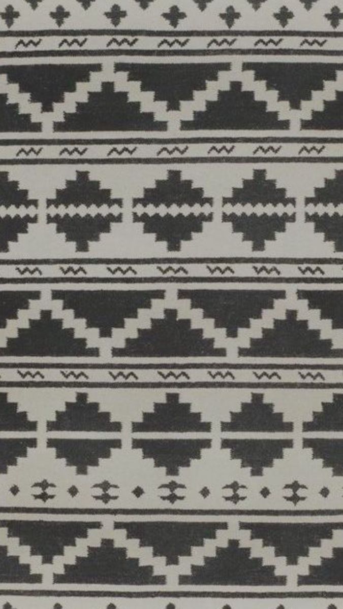 a black and white rug with geometric designs