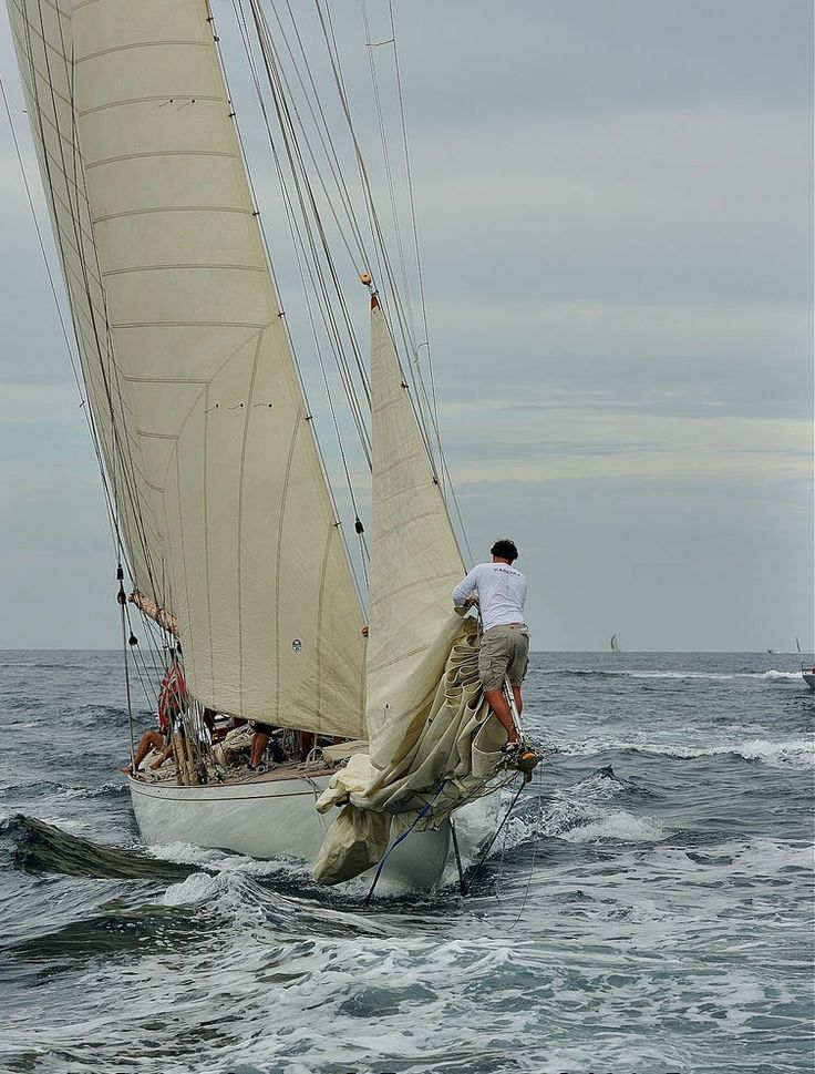 a man on a sailboat in the ocean