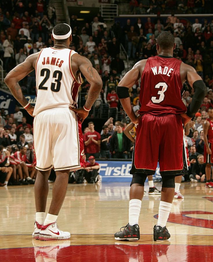 two basketball players are standing on the court