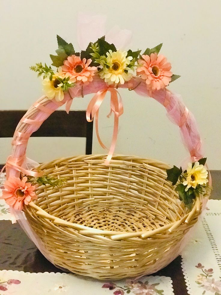 a wicker basket with flowers in it on a table