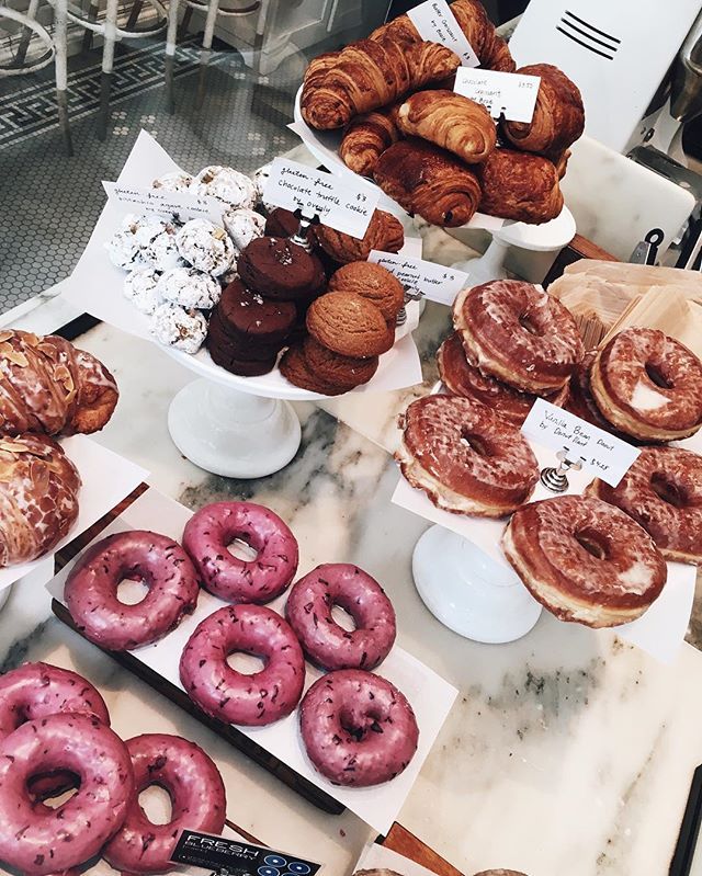 doughnuts and pastries on display at a bakery