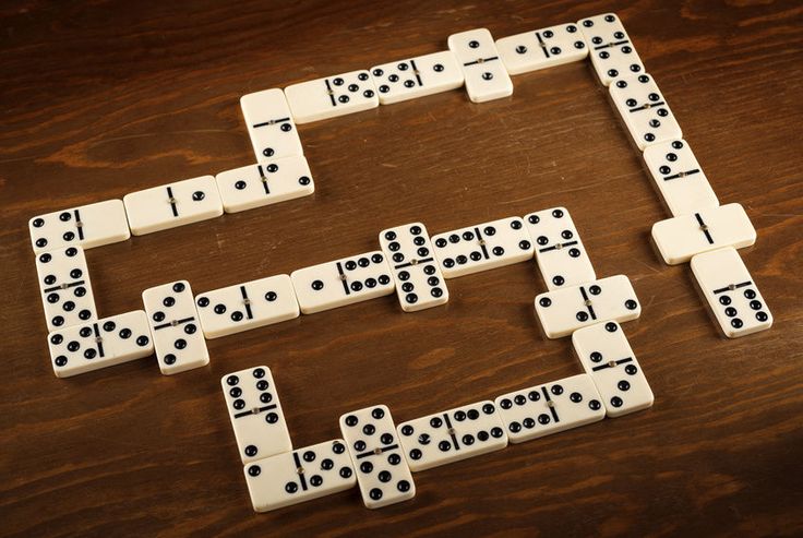 dominos laid out on a wooden table