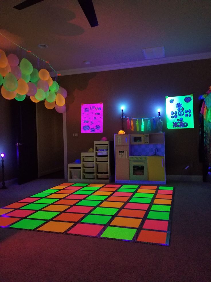 a room that has some lights on the ceiling and a dance floor in front of it