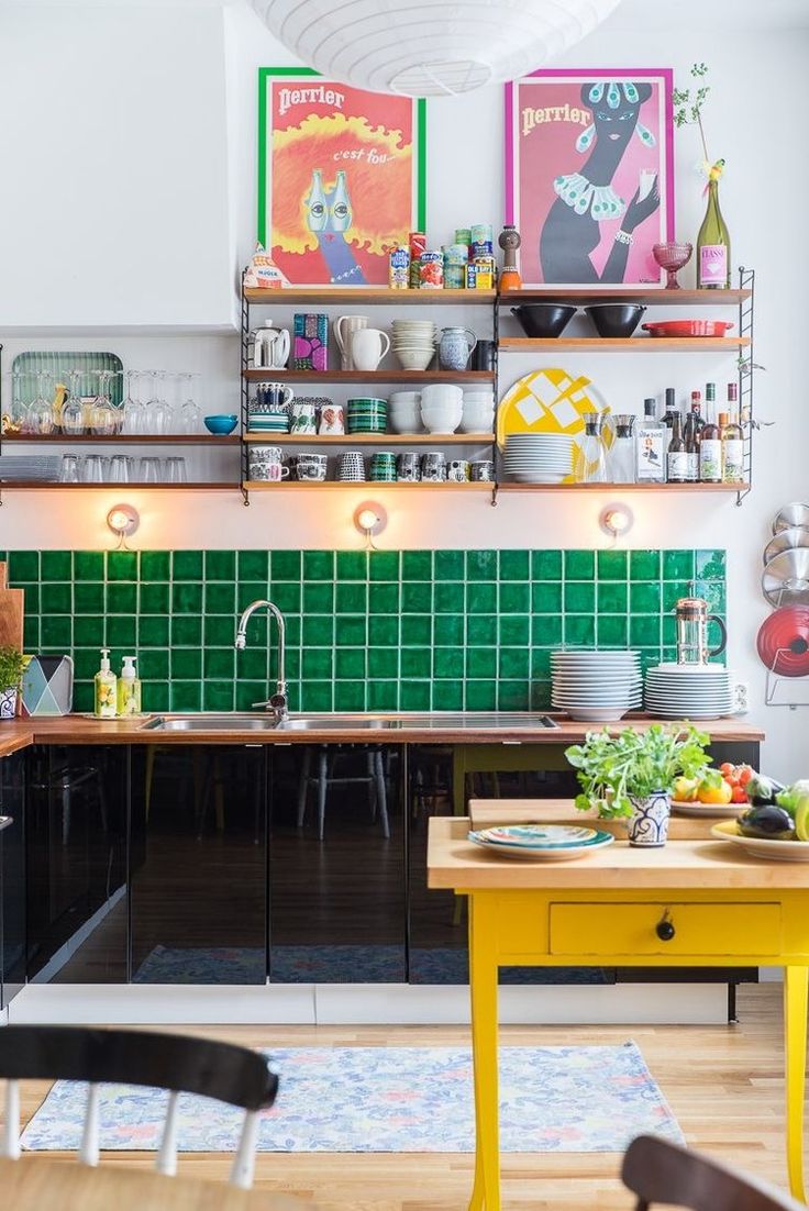 the kitchen is clean and ready to be used for cooking or eating, with green tiles on the wall