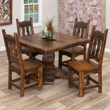 a dining room table and chairs in front of a stone fireplace