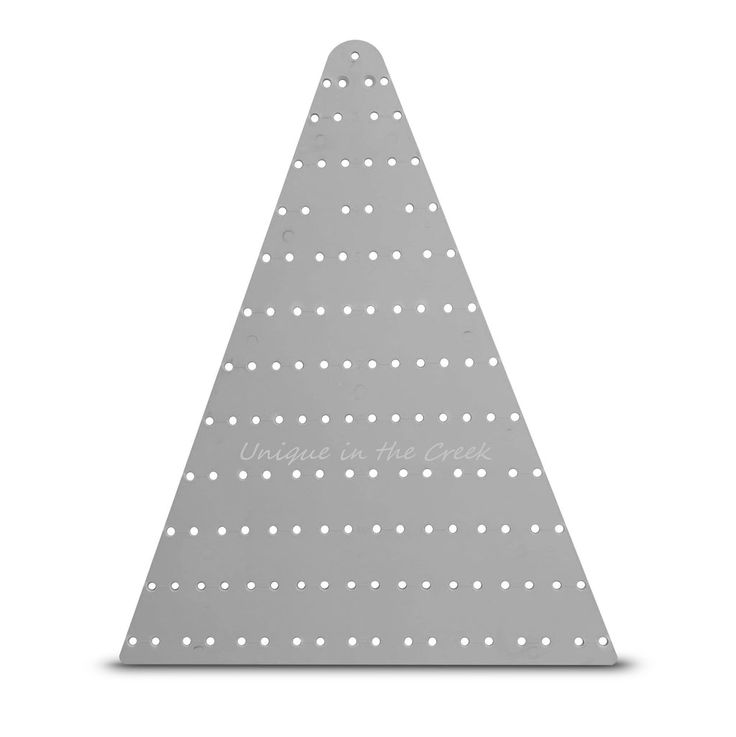 a triangle shaped metal object with white dots on the bottom and words unique in the middle