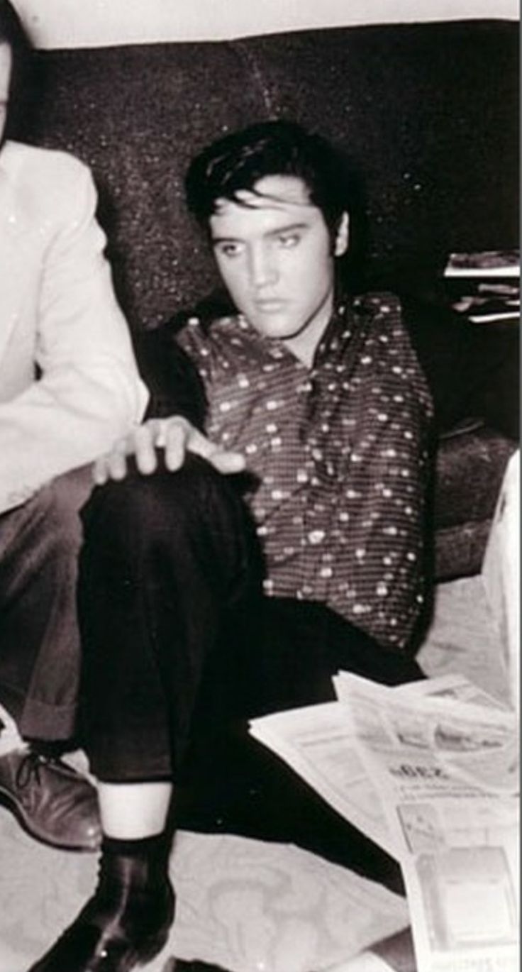 black and white photograph of two men sitting next to each other