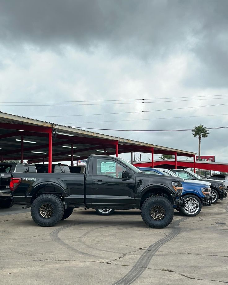 several trucks are parked in a parking lot