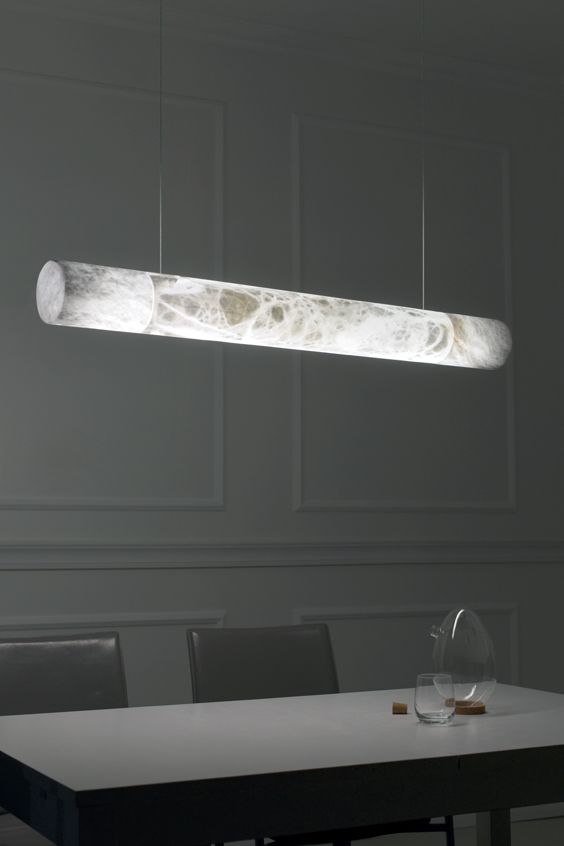 a table with chairs and a light hanging over it