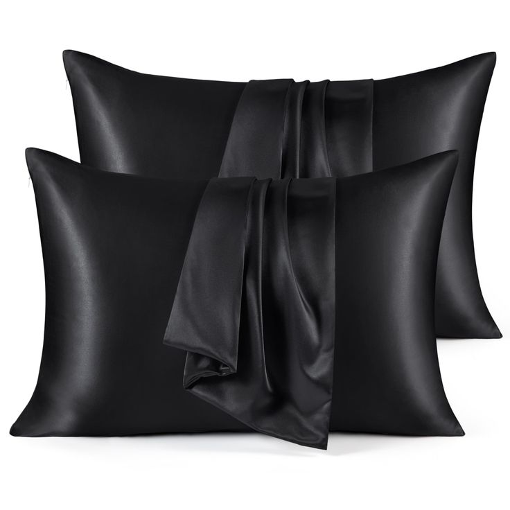 three black pillows with satin bows on them