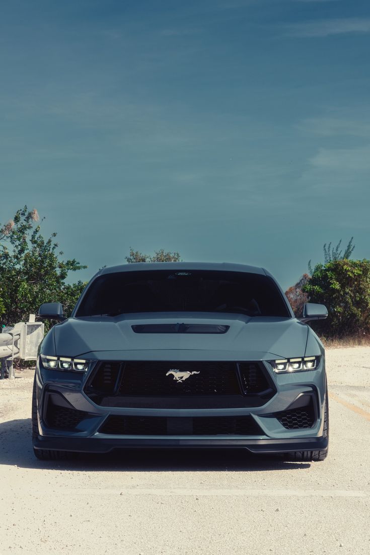 the front end of a gray sports car