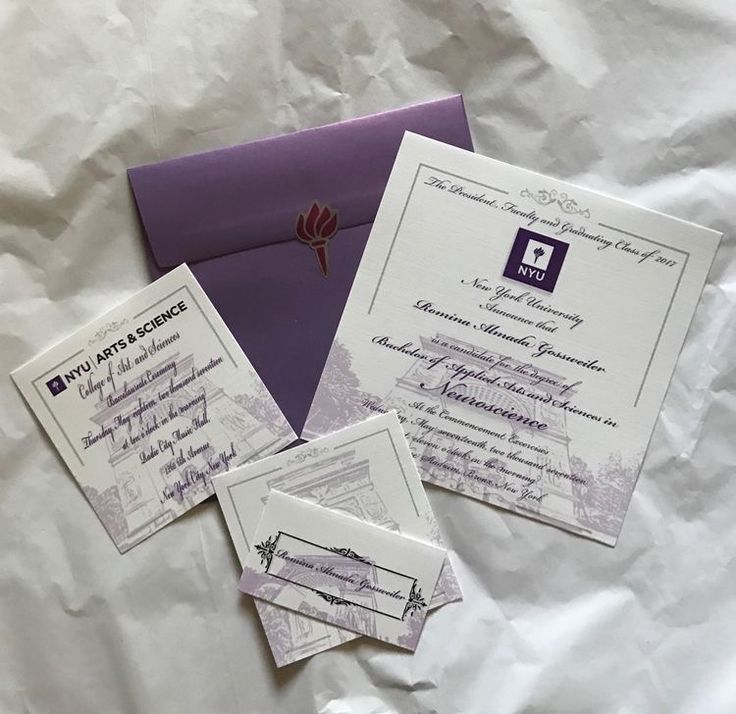 the wedding stationery is laid out on top of white paper and purple envelopes