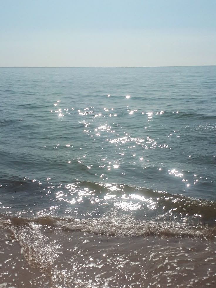 the sun shines on the water at the beach