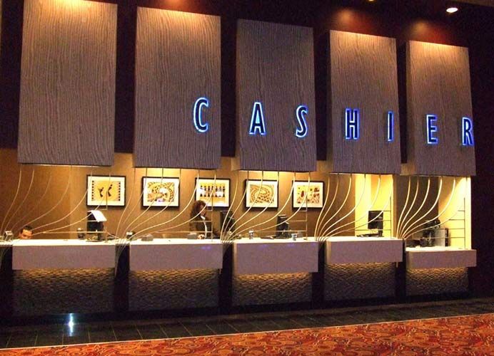 the cashier's counter is lit up in blue and white letters that spell out cashiers