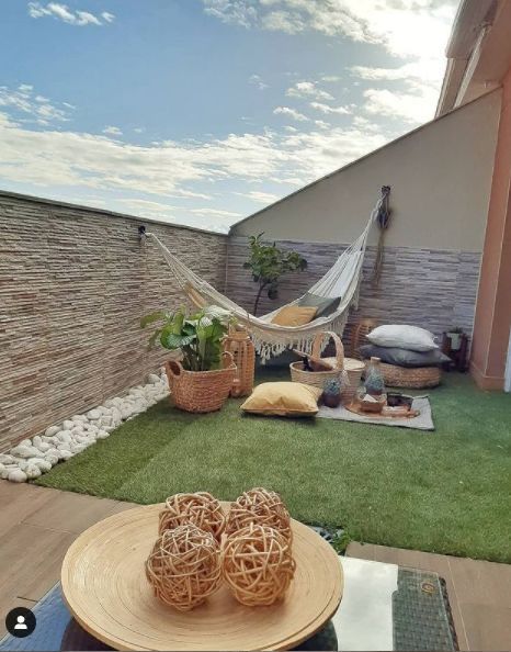 a hammock in the middle of a small backyard