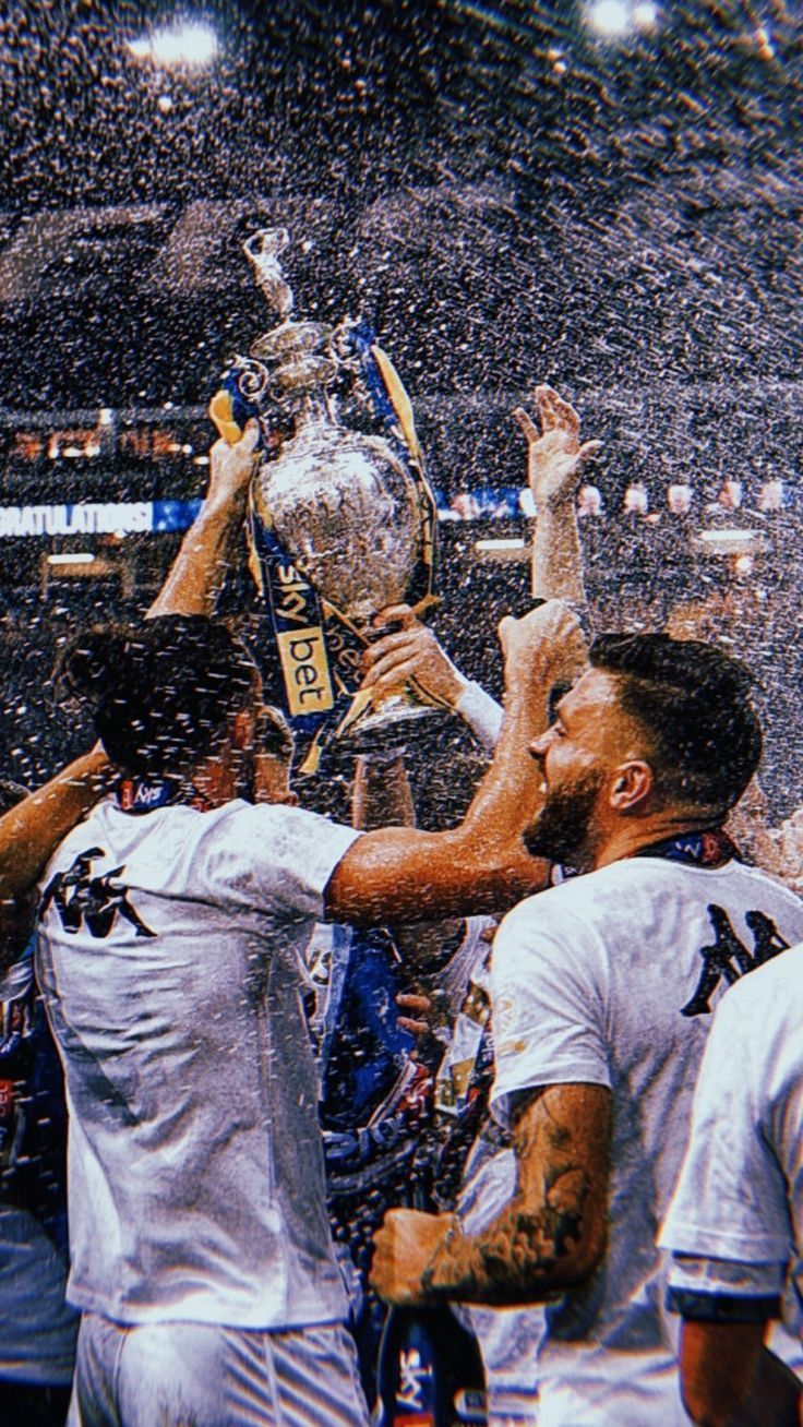 the baseball players are holding up their trophy and celebrating with confetti in front of them