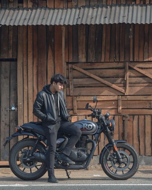 a man sitting on the back of a motorcycle