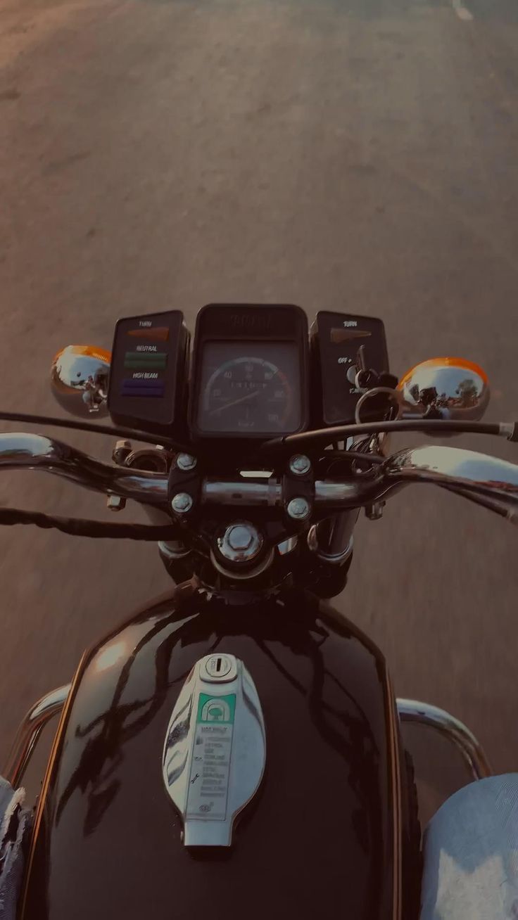 a close up view of the handlebars and dashboard of a motor cycle with an app on it