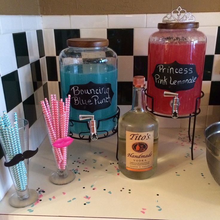 bottles and glasses on a counter with confetti sticks