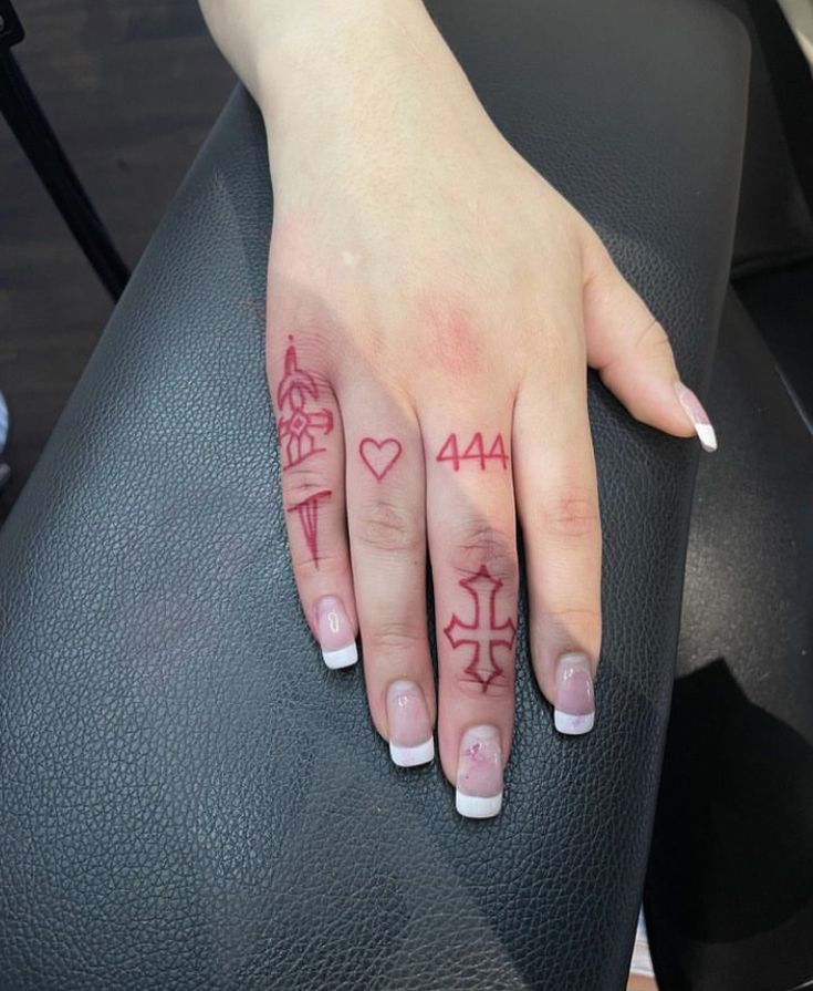 a woman's hand with tattoos on it