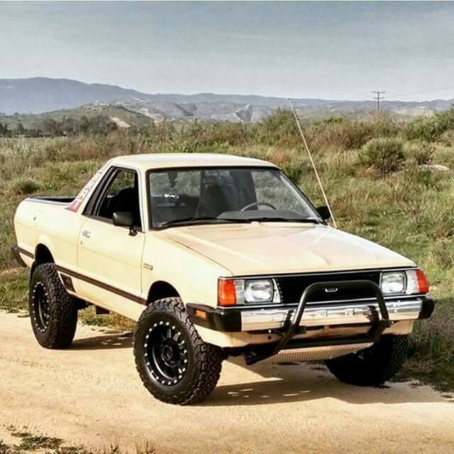 a white truck parked on top of a dirt road