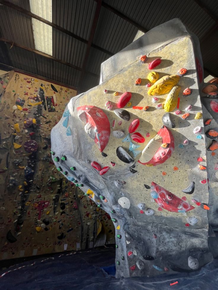 an indoor climbing wall with rocks and boulders