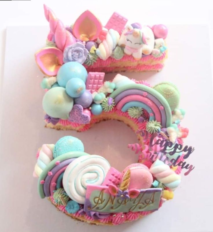 the number five is made out of cookies and decorated with fondant, icing, candy, and candies