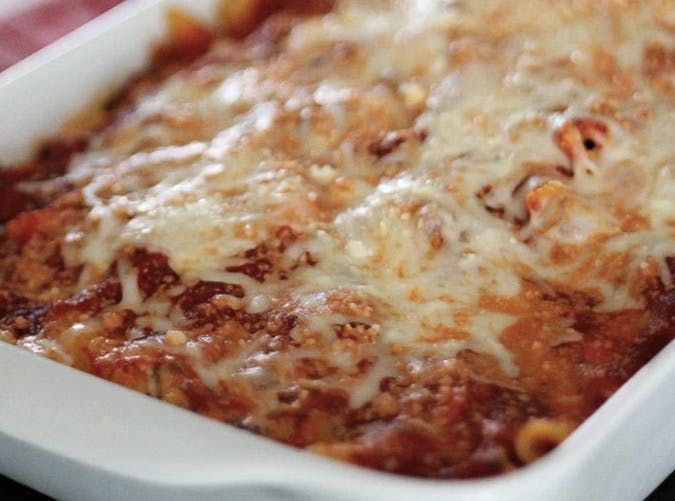 a casserole dish with meat and cheese in it