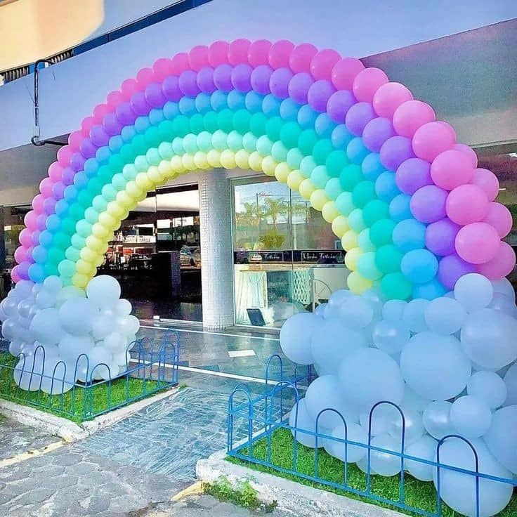 an arch made out of balloons in the shape of elephants and rainbows is shown