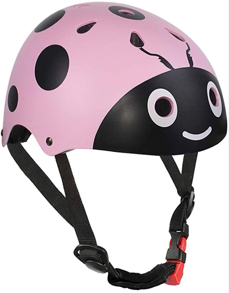 a child's helmet with a ladybug design on the front and side