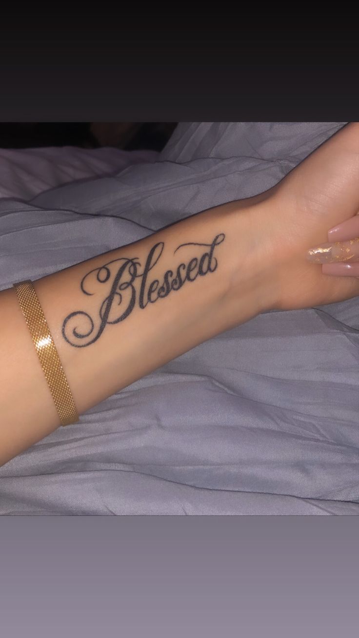 a woman's arm with a tattoo that says, blessed on it and the words below