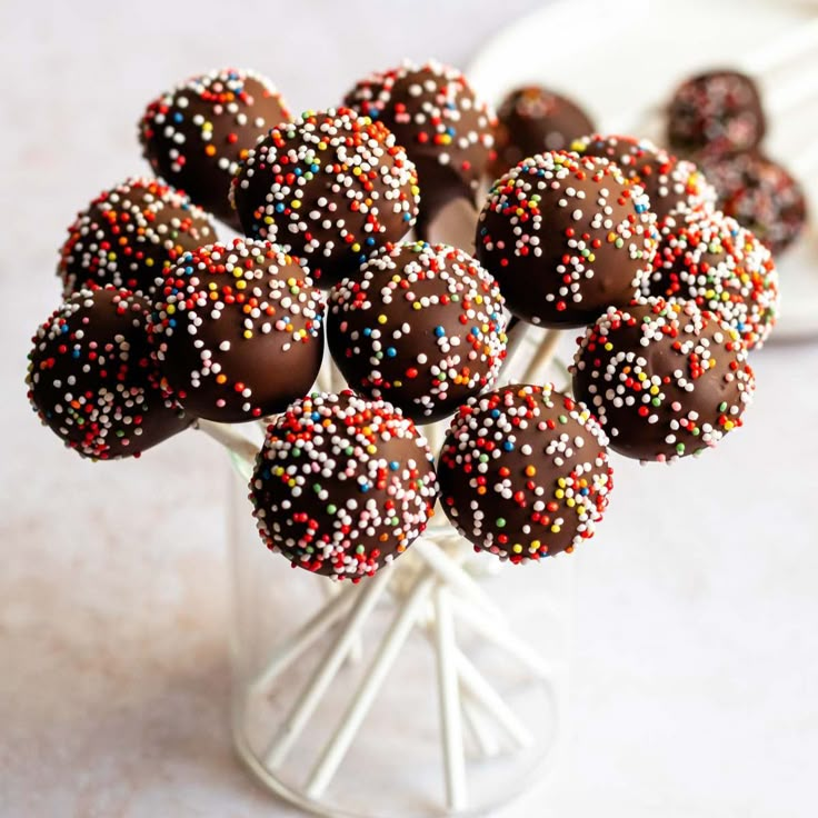 chocolate covered candies are arranged in a vase