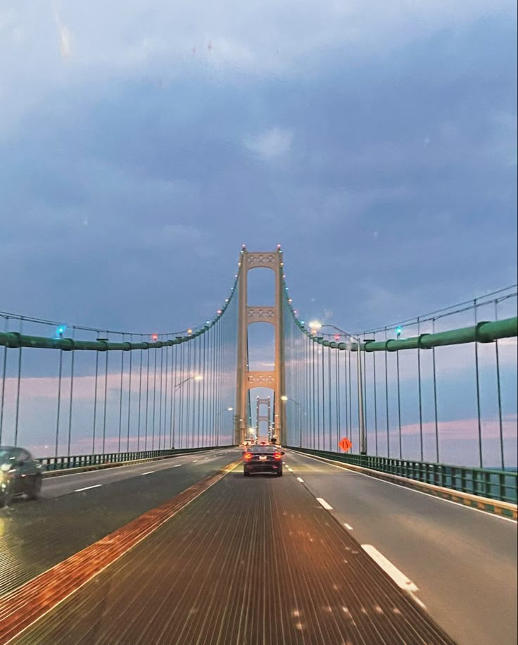 a car driving across a bridge over water