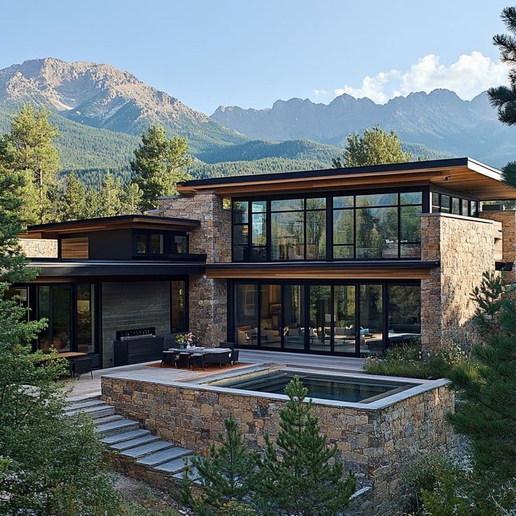 a modern house in the mountains surrounded by trees