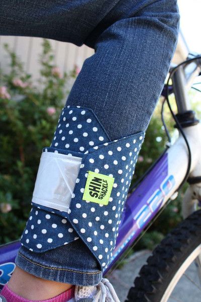 a close up of a person's feet on a bike with polka dot fabric