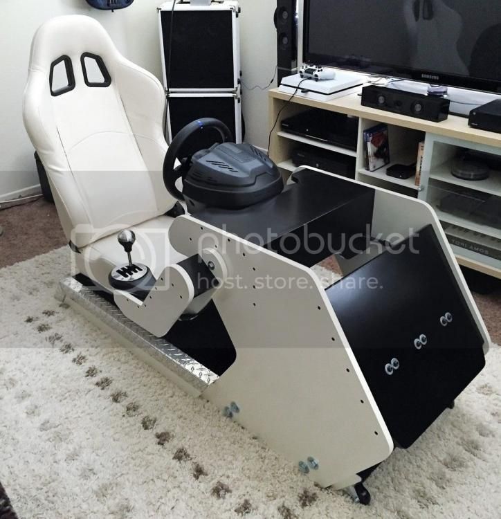 a gaming chair sitting on top of a rug in front of a flat screen tv