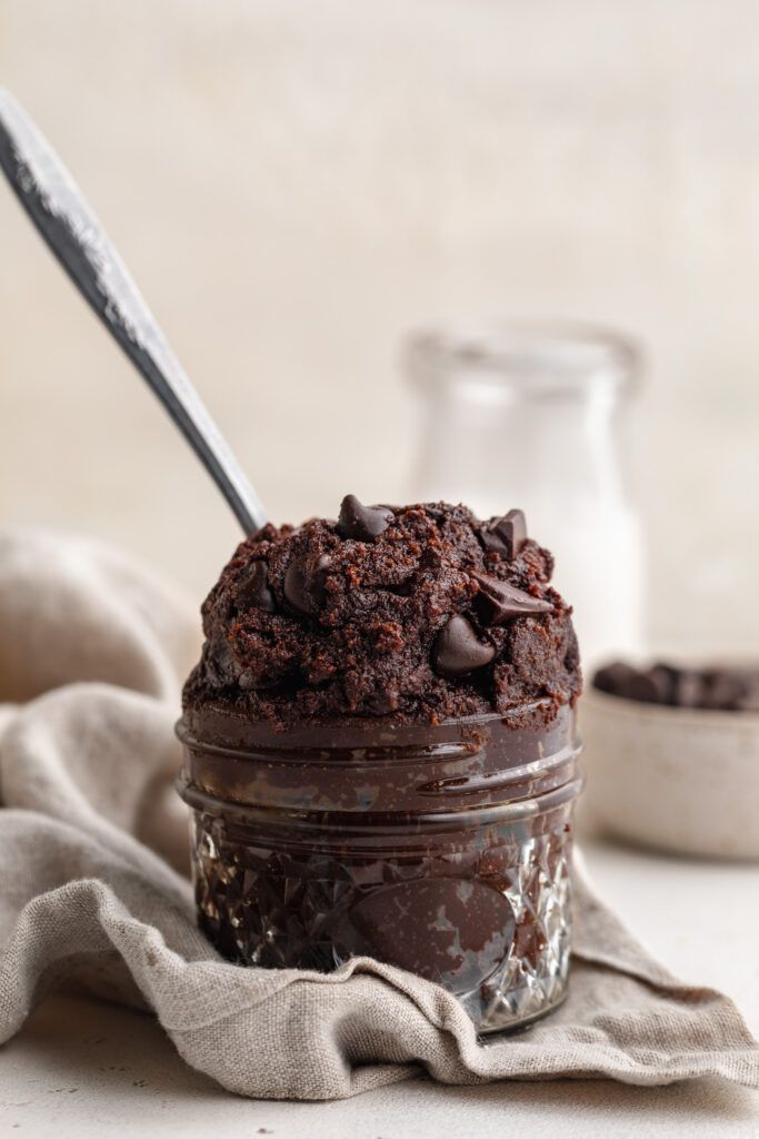 a chocolate cake in a jar with a spoon