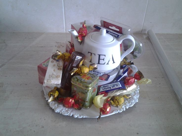 a tea pot filled with assorted candies and chocolates