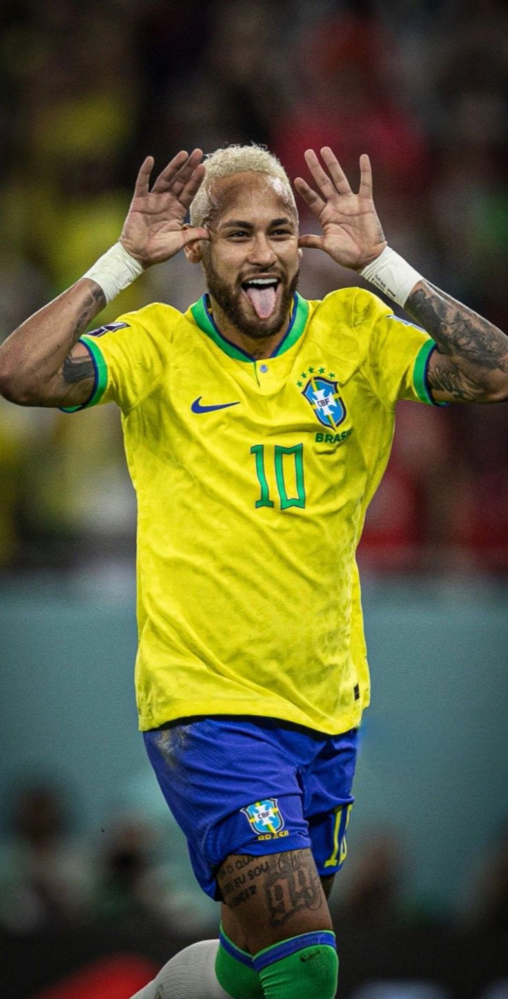 a soccer player with his hands in the air