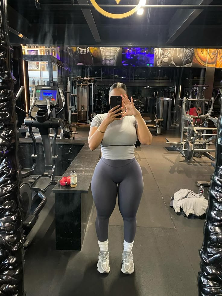 a woman taking a selfie in the gym