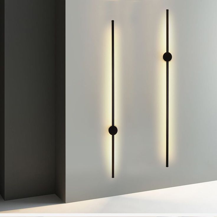 three lights that are next to each other in a room with white walls and flooring