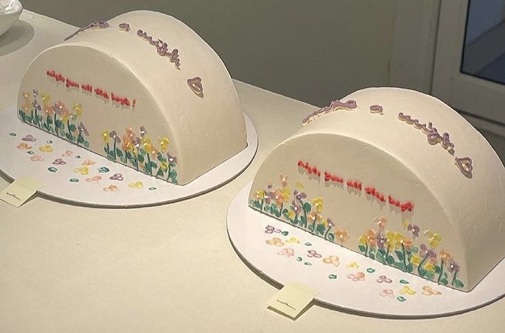 two cakes decorated with flowers and the words happy birthday